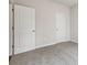 Bedroom with carpet, neutral walls, and two white doors at 3921 Brushy St, Powder Springs, GA 30127