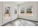 Bright breakfast nook with three windows offering a view of the outdoors and access to the backyard at 3921 Brushy St, Powder Springs, GA 30127