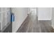 An interior view of a hallway showcasing vinyl flooring and neutral colored walls at 3921 Brushy St, Powder Springs, GA 30127