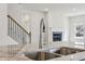 Modern kitchen sink and faucet with granite countertops, adjacent staircase and a fireplace in the background at 3921 Brushy St, Powder Springs, GA 30127