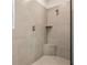 Modern shower with neutral tile, glass enclosure, and a convenient corner seat at 3921 Brushy St, Powder Springs, GA 30127