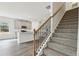 Inviting staircase adjacent to a modern kitchen with white cabinetry and stainless steel appliances at 3921 Brushy St, Powder Springs, GA 30127