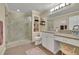 Well-appointed bathroom featuring a glass-enclosed shower and built-in storage shelves at 4760 Green Summers Dr, Cumming, GA 30028