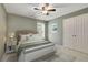 Virtually staged bedroom with a queen bed and double door closet at 4760 Green Summers Dr, Cumming, GA 30028