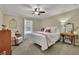 Charming bedroom with a queen bed and antique sewing machine desk at 4760 Green Summers Dr, Cumming, GA 30028