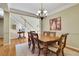 Formal dining room with hardwood floors, wainscoting, chandelier, and elegant table set at 4760 Green Summers Dr, Cumming, GA 30028