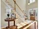 Light-filled foyer with hardwood floors, staircase, and a wooden front door with glass panes at 4760 Green Summers Dr, Cumming, GA 30028