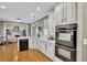 Modern kitchen with white cabinets, quartz countertops and stainless steel appliances at 4760 Green Summers Dr, Cumming, GA 30028