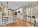 Modern kitchen with white cabinets, island, and breakfast bar at 4760 Green Summers Dr, Cumming, GA 30028