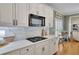 Modern kitchen features white cabinets, quartz countertops, and herringbone backsplash at 4760 Green Summers Dr, Cumming, GA 30028