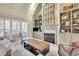 Bright living room with fireplace, built-in shelving, and large windows at 4760 Green Summers Dr, Cumming, GA 30028