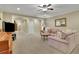 Spacious living room with neutral carpet and large TV at 4760 Green Summers Dr, Cumming, GA 30028