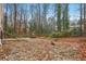 Large backyard with gravel and scattered leaves; under development at 3160 Hathaway Ct, Atlanta, GA 30341