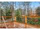 Deck with wooded views and glimpse of a residential street beyond at 3160 Hathaway Ct, Atlanta, GA 30341