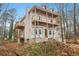 View of the side of a two-story home with unfinished construction, wooden balconies, and large bay windows at 3160 Hathaway Ct, Atlanta, GA 30341