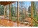 Screened porch with wooden deck overlooking a wooded area at 3160 Hathaway Ct, Atlanta, GA 30341