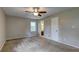 Spacious bedroom with neutral walls, plush carpeting, and ceiling fan at 418 Hillview Rd, Hampton, GA 30228