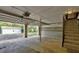 Spacious two-car garage with interior stairs and view of detached workshop at 418 Hillview Rd, Hampton, GA 30228