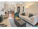 Inviting living room with hardwood floors, neutral walls, comfortable couches, and view into the dining area at 919 Ormewood Se Ave, Atlanta, GA 30316