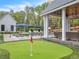 Luxury backyard oasis with pool, putting green, and covered patio at 103 Arbor Oaks Dr, Canton, GA 30115