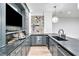 Sophisticated basement bar with dark cabinetry, granite countertops, and wine fridge at 103 Arbor Oaks Dr, Canton, GA 30115