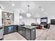 Modern basement bar with dark cabinetry, a large island, wine rack and beverage cooler at 103 Arbor Oaks Dr, Canton, GA 30115