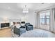 Relaxing main bedroom with light hardwood floors, plush seating, and large window with curtains at 103 Arbor Oaks Dr, Canton, GA 30115