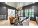 Luxurious home office features dark walls, large windows, and elegant furnishings at 103 Arbor Oaks Dr, Canton, GA 30115