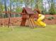 Wooden playset with slide and swings in grassy backyard at 103 Arbor Oaks Dr, Canton, GA 30115