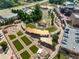 Aerial view showcasing a community amphitheater and plaza with artificial turf and brick walkways at 1149 Chastain Dr # 62, Sugar Hill, GA 30518