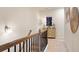 Second floor hallway featuring a decorative wall and railing at 1149 Chastain Dr # 62, Sugar Hill, GA 30518