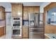 Stainless steel appliances and ample wood cabinets in this kitchen at 1833 Queens Way, Chamblee, GA 30341