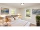 Cozy bedroom featuring neutral tones, framed art, and serene backyard views through two windows at 272 Old Sudie Rd, Hiram, GA 30141