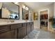 Bathroom featuring double vanity, framed mirrors, and large walk-in closet at 1121 Red Oak Ln, Loganville, GA 30052