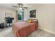 Bedroom featuring a bed, computer desk, ceiling fan, and a large window at 1121 Red Oak Ln, Loganville, GA 30052