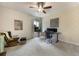 Bedroom with ceiling fan, a yellow patterned wall, and a cozy sitting area and workspace at 1121 Red Oak Ln, Loganville, GA 30052