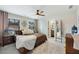 Bedroom with large bed, ceiling fan, and natural light from two windows at 1121 Red Oak Ln, Loganville, GA 30052