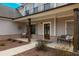 Inviting covered front porch with brick accents, wooden pillars, and cozy bench seating at 1121 Red Oak Ln, Loganville, GA 30052