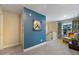 Second floor hallway with a blue accent wall, leading to bedrooms and bathrooms at 1121 Red Oak Ln, Loganville, GA 30052