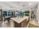 Open concept kitchen with island, farm sink, and view into living room at 1121 Red Oak Ln, Loganville, GA 30052