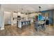 Modern kitchen and dining area with stainless steel appliances, granite countertops, and an island with barstool seating at 1121 Red Oak Ln, Loganville, GA 30052