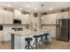 Modern kitchen with stainless steel appliances, granite countertops, and an island with barstool seating at 1121 Red Oak Ln, Loganville, GA 30052