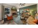 Warm living room featuring a brick fireplace, comfortable couches, and natural light at 1121 Red Oak Ln, Loganville, GA 30052