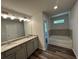 Main bathroom with double vanity, granite countertop, and soaking tub at 142 Tye St, Stockbridge, GA 30281