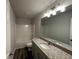 Bathroom with granite countertop, bathtub and light fixtures at 142 Tye St, Stockbridge, GA 30281