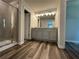 Bathroom with gray vanity, granite countertop, and walk-in shower at 142 Tye St, Stockbridge, GA 30281