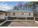 Ranch style home with a green metal roof and garden at 4785 Old Douglasville Rd, Lithia Springs, GA 30122