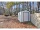 White storage shed in backyard with wooden fence at 4785 Old Douglasville Rd, Lithia Springs, GA 30122