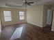 Bright bedroom featuring wood-look floors and two windows at 5138 Mcever View Dr, Sugar Hill, GA 30518