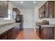 Modern kitchen with dark wood cabinets and granite counters at 5138 Mcever View Dr, Sugar Hill, GA 30518